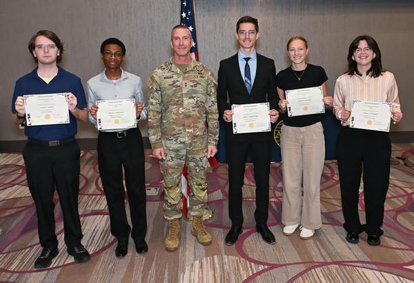 Weidner tands in the middle of five of the chapter's Spring Scholarship award recipients who were featured at the June luncheon. Students pictured from left to right are: Carston Wiebe, Junior University of Nebraska-Lincoln. Wiebe is working toward dual degrees in computer engineering and electrical engineering with a minor in math; Hassan Whitmore, incoming freshman, University of Nebraska -Omaha. Whitmore is working toward a degree in architectural engineering; Liam Taubenberger, sophomore, University of Nebraska-Omaha. Taubenberger is working toward dual degrees in engineering physics and mathematics; Delaney Lawrence, recipient of the Sterling Computers Scholarship, Senior University of Nebraska-Lincoln. Lawrence is working toward a degree in computer science; and Kahlan Campbell, sophomore, University of Kansas. Campbell is working toward a degree in Aerospace Engineering. In addition, there were two scholarship recipients who could not be present: Samuel Verdoni, Junior Benedictine College. Verdoni is working toward a degree in accounting with minors in mathematics and theology; and Joshua Jansen, sophomore, Benedictine College. Jansen is working toward a degree in business/construction management. The chapter awarded a total of $20,000.