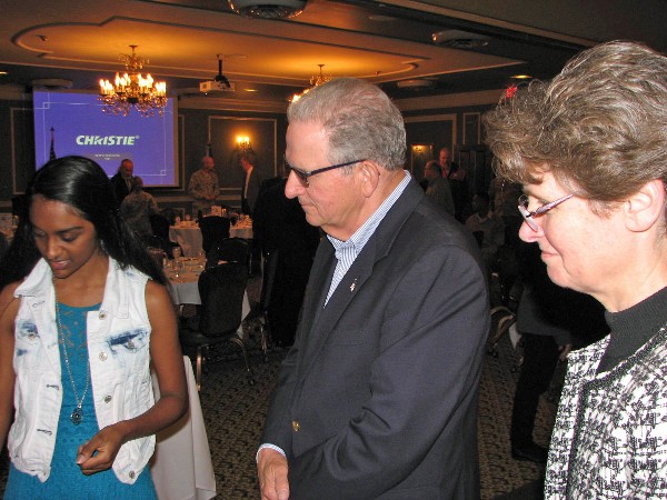 Kumar (l), an eighth-grader at Alice Buffett Magnet Middle School in Omaha, Nebraska, describes her science fair project to Dorest Harvey (c), the chapter's member at large, and Giorlando in April. 