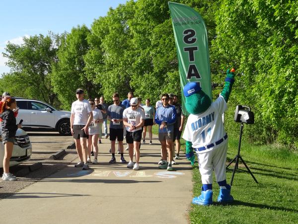 Pictured are the 5K participants for the Chapter's tenth 5K held at Walnut Creek Park in Papillion, Nebraska, in May.  Runners are waiting for Stormy to start the race.