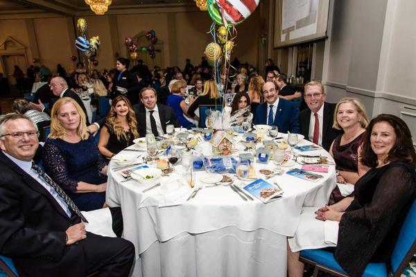 In December, members attend the Gingerbread Ball, benefitting Fisher House Foundation.