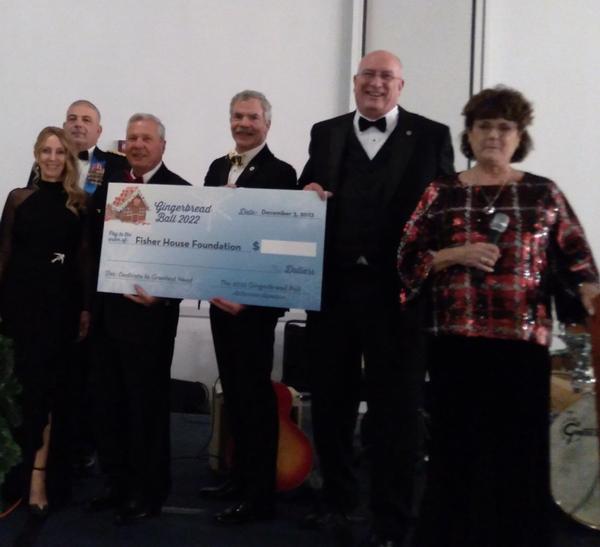 At the December event, members await the amount for the check going to Fisher House Foundation.
