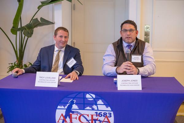Veterans Administration Technology Acquisition Center contracting officers, Troy Loveland and Joseph Jones, engage in a Q and A session during the April event.