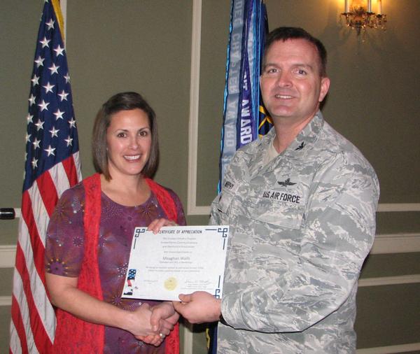 Meaghan Walls (l), president and CEO, Assistology, LLC, Omaha, Nebraska, is pictured with Col. Sean Murphy, USAF, chapter president.  Walls receives a chapter coin for presenting at the January luncheon.