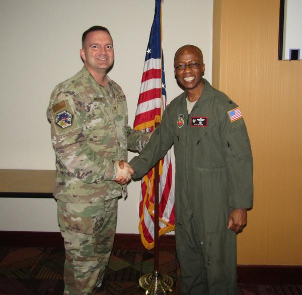 Col. Sean Murphy, USAF, chapter president (l), shakes hands with Col. Gavin Marks, USAF, commander, 55th Wing, Offutt Air Force Base, Nebraska. Col. Marks was the speaker for the January luncheon and received a Greater Omaha Chapter coin for addressing the chapter.