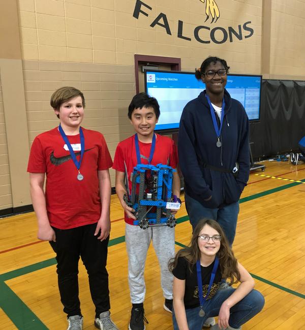 Pictured (l-r) are members of the Logan Fontenelle Middle School Robotics B-Team from Bellevue, Nebraska: Caleb Winterbottom, Nguyen Phan, Martha Hinnen, and Cadence Montgomery (Front). Not pictured is Rachel Byington.