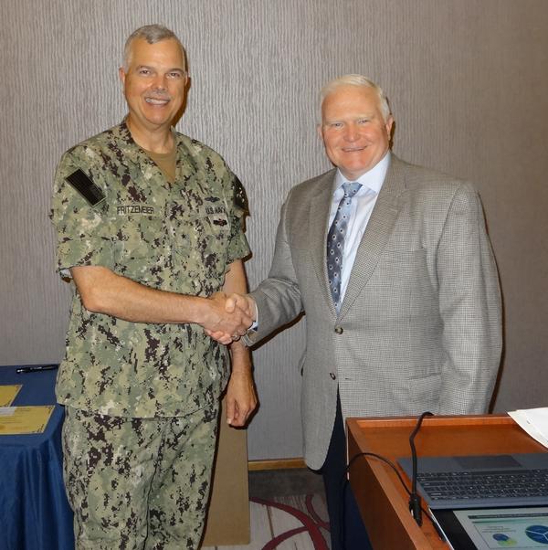 Rear Adm. Ronald Fritzemeier, USN (l), director, Nuclear Command, Control and Communications Enterprise Center, U.S. Strategic Command, Offutt Air Force Base, Nebraska, shakes hands with Jerry Gandy, chapter executive vice president, at the June event. Adm. Fritzemeier received a chapter coin for being the June guest speaker.