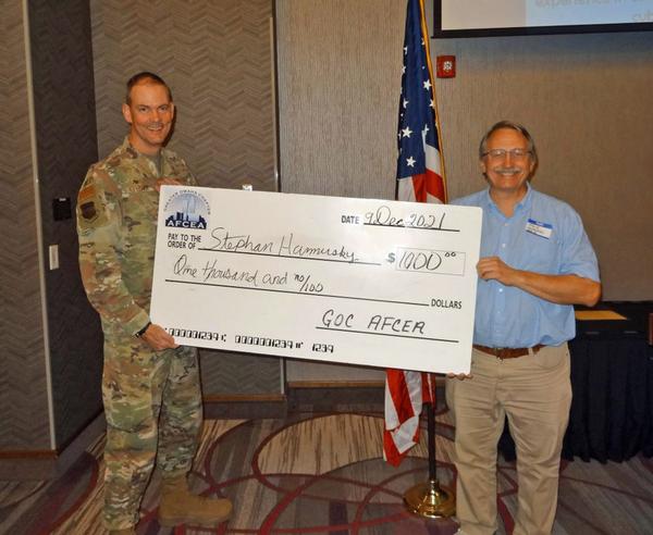 In December, Col. Larry Fletcher, USAF (l), chapter president, presents the big check to Steve Hamersky, high school teacher of science, computer programming, robotics and engineering, Daniel J. Gross High School, Bellevue, Nebraska. Hamersky will procure drones and microcontrollers for use in STEM courses, extra-curricular programs and summer camps.