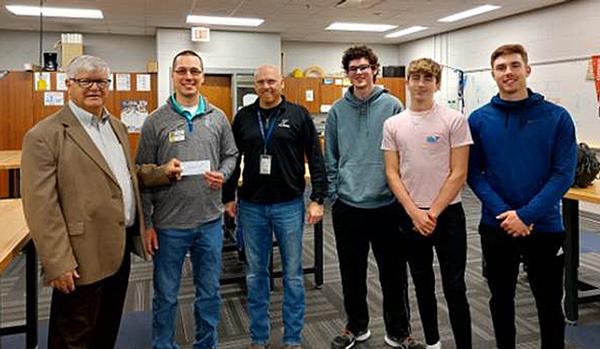 In April, Bernard Lichvar (far l), chapter grant coordinator, hands over a check funded by the La Vista Community Foundation to (l-r) Randy Stribley, robotics teacher, Skilled and Technical Sciences Department, Papillion-La Vista South High School, Papillion, Nebraska; Jamie Glover, Career and Technical Education, Skilled and Technical Sciences Department head, Papillion-La Vista South High School; Josiah Mayfield, 12th-grade student, Papillion-La Vista High School, member of Robotics Club Team; Austin Brakenhoff, 12th-grade student, Papillion-La Vista High School, member of Robotics Club Team; and Logan Brickman, 12th-grade student, Papillion-La Vista High School, member of Robotics Club Team.�

