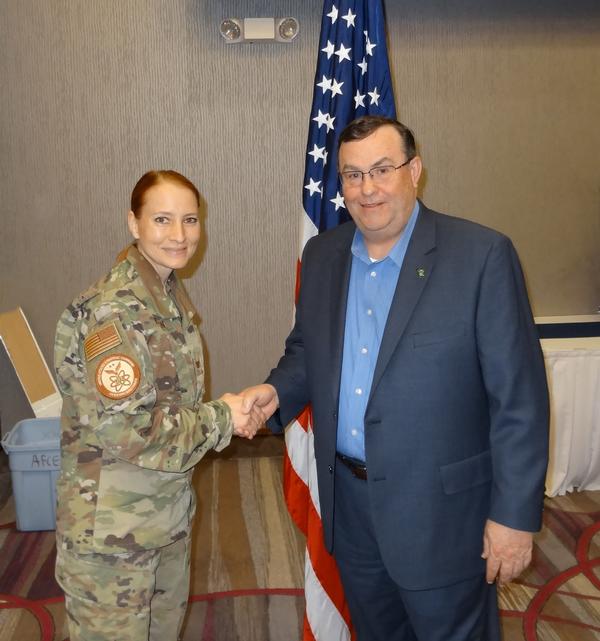 Col. Janel Nelson, USAF, chapter vice president of academics (l), shakes hands with Jeffrey Weeks, senior vice president and chief information security officer, First National of Nebraska, Omaha, Nebraska. Weeks briefed the assembly on cyber threats and security; what his office does to keep cyber threats under control across the financial organization; and what we can do on our own to have a solid cybersecurity regimen.�
