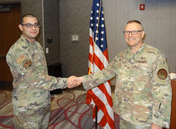 In August, Staff Sgt. Jaedon Resto, USAF, chapter vice president of programs (l), shakes hands with Col. Jason Mobley, USAF, commander, Defense Information Systems Agency Field Office, Offutt Air Force Base, Nebraska. Col. Mobley presented Sgt. Resto with a DISA Field Office CC coin for doing an excellent job keeping the luncheon on track despite the lack of electricity, which was eventually restored just before the luncheon began.�
