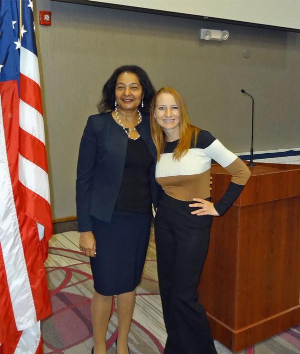 Janel Nelson (r), chapter president, stands next to Sajda Qureshi (l), director, Information Technology for Development, University of Nebraska, Omaha, Nebraska.  Qureshi was the speaker for the October luncheon and received a Greater Omaha Chapter coin for addressing the chapter.