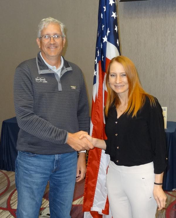 Douglas Durham, CEO, Don't Panic Labs, Lincoln, Nebraska (l), shakes hands with Janel Nelson, chapter president. Durham was the speaker for the February Luncheon and received a chapter coin for addressing the attendees.
