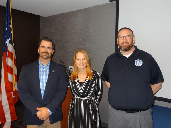 In May, Ethan Cole, deputy regional director, U.S. Department of Homeland Security, Cybersecurity and Infrastructure Security Agency, Region 7, Kansas City, Missouri (l), Janel Nelson, chapter president, and Warren Hagelstien, cybersecurity advisor, Region 7, Omaha, Nebraska (r), pose for a photo. Cole was the speaker for the May luncheon and received a Greater Omaha Chapter coin for addressing the chapter.