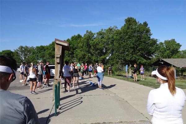 Janel Nelson, chapter president, provides welcome comments to participants in the chapter's 7th Steps for STEM 5K held in May at Walnut Creek Lake in Papillion, Nebraska.