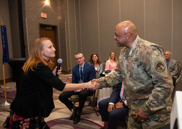 Janel Nelson, chapter president, shakes hands with Gen. Anthony Cotton, USAF, commander, U.S. Strategic Command, Offutt Air Force Base, Nebraska.  Gen. Cotton was the speaker for the June luncheon and received a Greater Omaha Chapter coin for addressing the chapter.