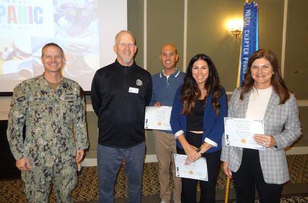 Capt. Merkle presents certificates to several chapter members who were recognized as 