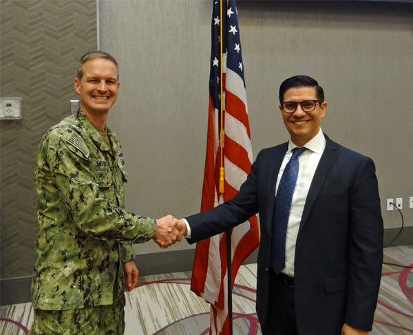 Capt. Thomas Merkle, USN (l), chapter president, shakes hands with Pedro Ramirez, senior technical advisor, Nuclear Command, Control, and Communications Enterprise Center, Offutt Air Force Base, Nebraska, during the March event. Ramirez was the speaker for the March luncheon and received a Greater Omaha Chapter coin for addressing the chapter.