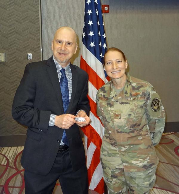 Ron Woerner, senior security and risk consultant, Forrester Research, Cambridge, Massachusetts (l), stands next to Col. Janel Nelson, USAF, chapter executive vice president. Woerner was the speaker for the April luncheon and received a Greater Omaha Chapter coin for addressing the chapter.