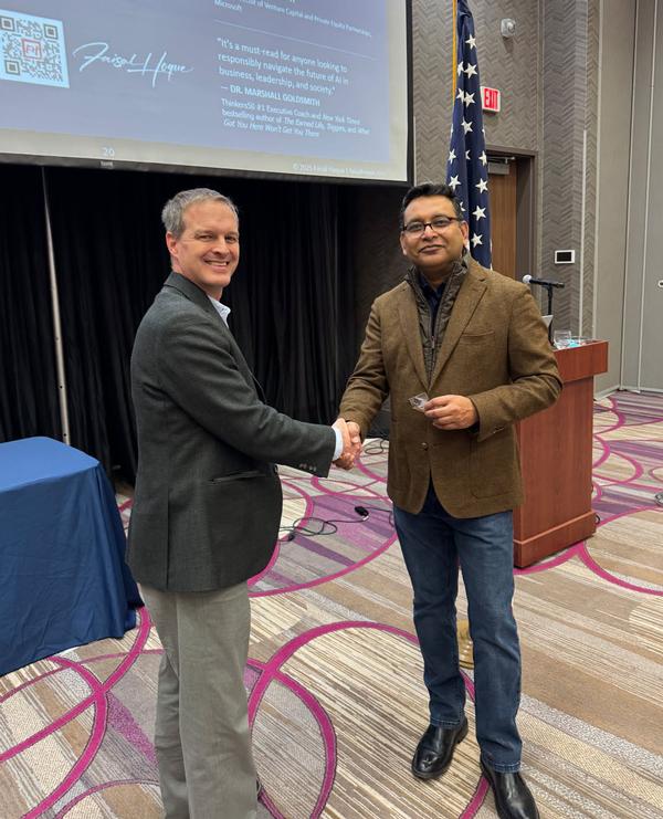 Thomas Merkle, chapter president (l), shakes hands with Faisal Hoque, founder of Shadoka; entrepreneur, author  and  technologist, Stamford, Connecticut.  Hoque was the speaker for the January luncheon and received a Greater Omaha Chapter coin for addressing the chapter.
