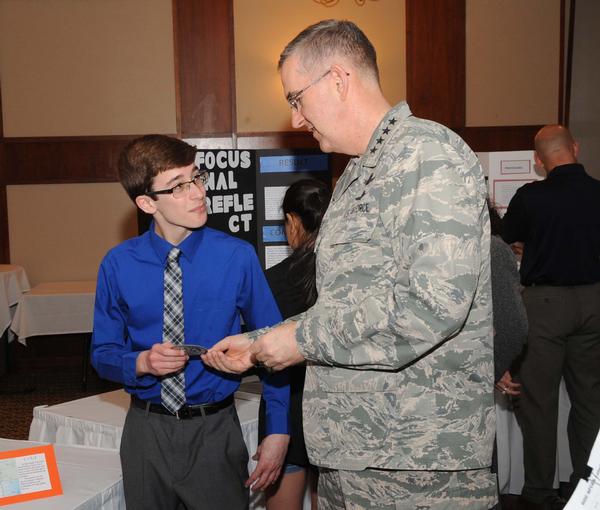 Gen. Hyten presents Josh Gryzen (l), Buffett Magnet Middle School, a STRATCOM patch in April for his efforts from the Omaha Metropolitan Science and Engineering Fair (MSEF).