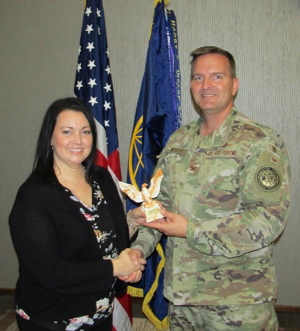 At the October event, Diane Kremer, teacher, R.M. Marrs Magnet Middle School, Omaha, Nebraska (l), shakes hands with Col. Murphy. Kremer received the chapter's Volunteer of the Year award for her selfless contribution of time to support chapter activities.