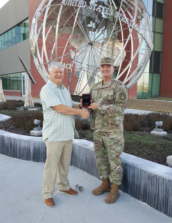 In November (from l-r) Bernie Lichvar, chapter grant coordinator, shakes hands with Col. Sean Murphy, USAF, chapter president, in front of the new U.S. Strategic Command's Command and Control Facility as Col. Murphy presents Lichvar with his AFCEA Meritorious Service Award. Lichvar is a tremendous supporter of chapter events and has significantly extended the chapter's grant submissions over the past year.