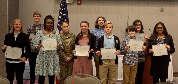 Col. Nelson poses for a photo with nine of the 10 award recipients from the Omaha Metropolitan Science Fair featured at the chapter luncheon in April. Students pictured (l-r) are: Ella Humphrey, 12th Grade, Zoo Academy, Omaha, Nebraska, Silver Carp Growth During Flooding; Charlie Gutzmann, 8th Grade, Gerald Otte Blair Middle School, Blair, Nebraska, Caesar Cypher Decryption; Tamlin Clark, 8th Grade, Omaha Virtual School, Omaha, Nebraska, Butterfly Wings Angle Investigation; Alivia Moore, 8th Grade, Omaha Virtual School, Omaha, Nebraska, How Does Recycled Plastic Affect Concrete; Jonas Morgan, 8th Grade, King Science and Technology Center, Omaha, Nebraska, Prosthetic Package; Thomas Schaben, 7th Grade, St. Cecilia Cathedral School, Omaha, Nebraska, Air Pressure and Rockets; Maxwell Langton, 7th Grade, McMillan Magnet Center, Omaha, Nebraska, How Do Gear Ratios Affect the Speed and Strength of a Motor?; Landon Salazar, 8th Grade, Beveridge Magnet Middle School, Omaha, Nebraska, The Fluidized Bed; and Siri Doddapeneni, 9th Grade, Brownell Talbot School, Omaha, Nebraska, Ride the Wave. Projects were accessed virtually from in March by a special chapter panel. The chapter awarded a total of $1,800.�
