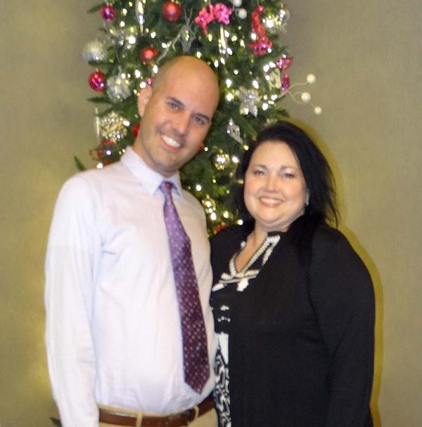 Samuel Fischer (l), language arts teacher, grades 6-8, R.M. MARRS Magnet Center, Omaha, stands next to Campbell (r). Fischer served as the emcee during the Holiday Mixer Event. 