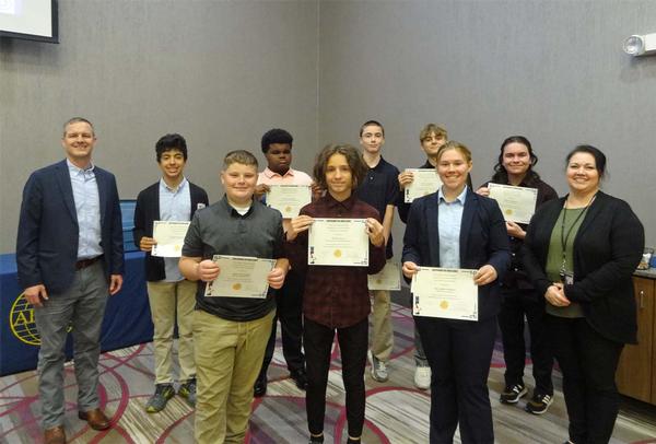 Thomas Merkle, chapter president (l), stands next to nine of the award recipients from the Omaha Metropolitan Science Fair that were featured at the chapter luncheon in April. Students pictured (l-r) are: Joseph Kwapnioski, St. Cecilia's Cathedral School, Omaha, Nebraska, seventh grade, How Far Does Electricity Transfer Wirelessly;  Spencer Hartig, Bennington Middle School, Bennington, Nebraska, sixth grade, A Blueprint for Building Stability; Nevin Gonzales, King Science and Technology Middle School, Omaha, eighth grade, How Many Different Materials Stand Up Against an Earthquake?; Oliver Gura, King Science and Technology Middle School, Omaha, eighth grade, Human/AI Articles; Adrian Biegger, King Science and Technology Middle School, Omaha, eighth grade, Water+Flooding=Dams; Henry Castens, Omaha Central High School, Omaha, 11th grade, How Summative to Formative Weight Effects Graduation Rate; Mercedes Renken, UNMC High School Alliance, Omaha, 12th grade, The Impact of Ethylenediaminetetraacetic Acid on the Coefficient of Friction Between Ultra-High Molecular Weight Polyethylene and Cobalt Chrome; Aiden Whalen, Omaha Central High School, Omaha, 12th grade, Exploring the Statistical Similarities Between a Reverse Osmosis System and a Home-Made Water Filtration System in their Ability to Remove Contaminants;and not pictured, Aishwarya Pandharpurkar, Elkhorn Valley View Middle School, Elkhorn, eighth Grade, Amplifying Wi-Fi Around Water With Parabolic Reflectors. Also pictured is Diane Campbell, chapter vice president of academics, who was the team lead in the evaluation/selection of student projects. Projects were accessed at the Henry Doorly Zoo in March. The chapter awarded a total of $1,500.