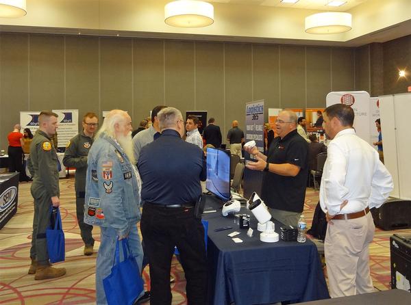 Attendees enjoy visiting booths at the October event.