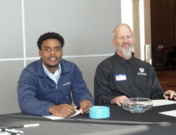Daniel Campbell (l), copywriter, Venel - Orthopaedic Marketing, Omaha, is pictured with Scott Stevens, chapter corporate liaison. Campbell and Stevens worked the check-in for the chapter's Annual Holiday Mixer event, which was held at the Beardmore Event Center in Bellevue in December.
