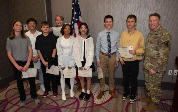 Eubank poses for a photo with eight of the award recipients from the Omaha Metropolitan Science and Engineering Fair, who were recognized at the luncheon in April. Students pictured (l-r) are Austin Ordway, 8th grade, King Science and Technology Middle School, Omaha, Nebraska; Logan Ridder, 8th grade, Lifegate Christian School, Omaha; Mandy Lao, 7th grade, Alice Buffet Middle School, Omaha; Mariyah Broadway, 7th grade, Alice Buffet Middle School; Ace Steinke, 8th grade, Beveridge Middle School, Omaha; Daniel Hall, 7th grade, Alice Buffet Middle School; Jericho Pierce, 8th grade, King Science and Technology Middle School; Cameron Mello, 8th grade,  Bennington Middle School, Omaha; and not pictured due to participation in the Nebraska State Science Competition in Lincoln, Nebraska, is Athreya Reddy, 10th grade, Elkhorn South High School, Elkhorn, Nebraska. All projects were assessed at the Henry Doorly Zoo in March. The chapter awarded a total of $1,200.