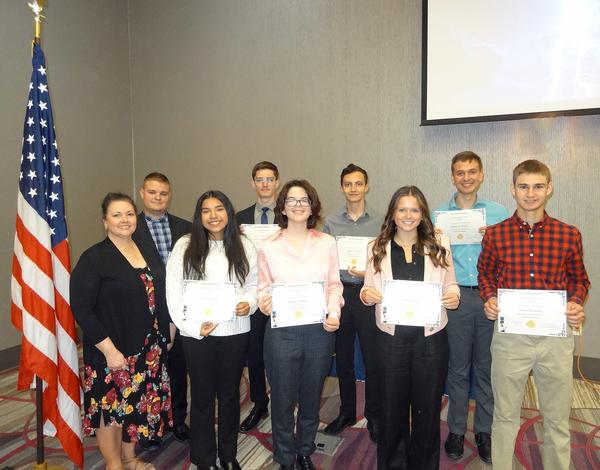 Diane Campbell, chapter vice president of academics, stands next to eight of the chapter's Spring Scholarship Award recipients, who were featured at the luncheon in May. Students pictured from left to right are Eric Shepley, Junior University of Nebraska-Omaha, working toward a degree in management informational systems; Jimena Munoz, incoming freshman, Creighton University, working toward a degree in biology and art; Liam Taubenberger, incoming freshman, University of Nebraska-Omaha, working toward a degree in engineering physics with a minor in math; Kahlan Campbell, incoming freshman, University of Kansas, working toward a degree in aerospace engineering; Seamus Halderman, sophomore, University of Nebraska-Omaha, working toward a degree in computer science/artificial intelligence; Reese Aliano, sophomore, University of Nebraska-Lincoln, working toward a degree in civil engineering; Samuel Verdoni, sophomore, Benedictine College, working toward a degree in accounting with minors in mathematics and theology; Joshua Jansen, incoming freshman, Benedictine College, working toward a degree in mechanical engineering; and not pictured is Ella Oney, graduate student, University of Nebraska-Omaha, working toward a degree in cybersecurity. The chapter awarded a total of $14,000.