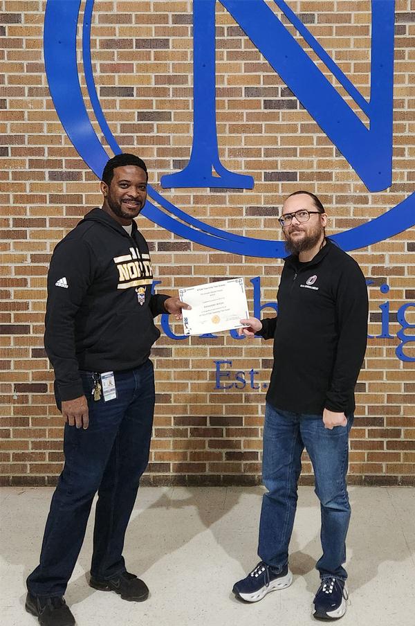 Christopher Humphries, principal, Omaha North High School, Omaha, Nebraska (l), and Alexander Anton, teacher, Omaha North High School, Omaha, pose for a photo. Anton was unable to attend the Holiday Mixer. Humphries presented Anton with his Greater Omaha Chapter of AFCEA STEM Grant certificate and check.  Anton teaches grades 9-12 in advanced biology, anatomy, health informatics and biomedical sciences.  He thanked the chapter for the opportunity to better serve his students!