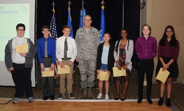 In April, Gen. Hyten (c) recognizes recipients of chapter awards from the MSEF and their projects, including (l-r) Tommy Krause, Lifegate Christian Middle School (Display Disarray); Gryzen (A Flash of Light, Enlighten Yourself); Luke Nielan, Buffett Magnet Middle School (Searching? Please Wait); Thy Doan, Buffett Magnet (High Focusing Signal: Let's Reflect); Shruthi Kumar, Marian Catholic High School (Steer Clear); Megan Belongia, Omaha North Magnet High School (The Use of Modern Open Source Hardware to Demonstrate the Deficiency of the Blackjack Basic Strategy and True Count Method); and Anjali Pullabhotla, Millard North High School (The Automated Diagnosis of Heart Disease).   