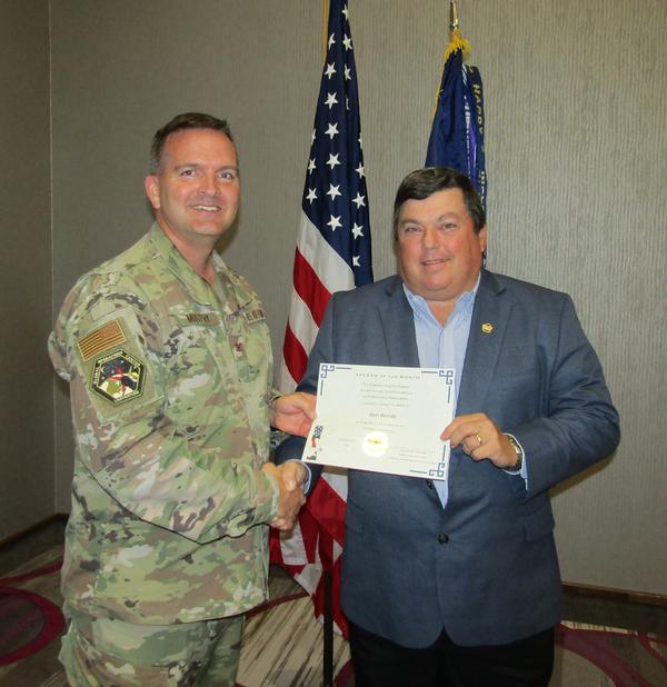 Murphy shakes hands with Benjamin Beede, chapter golf chairperson (r). Beede was recognized as the AFCEAN of the Month for his efforts as project lead of the chapter's 18th Annual Golf Tournament in October.