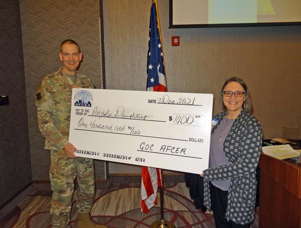 In December, Col. Fletcher presents the big check to Angela Daughtrey, high school teacher of precalculus, calculus, advanced placement math, Bellevue West High School, Bellevue, Nebraska. Daughtrey is building a puzzle library with store-bought STEM puzzles as well as homemade ones that will not only be used in her classroom, but also can be used by other teachers/students in the math and science department.