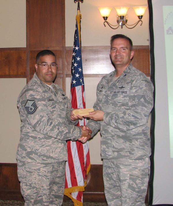 Col. Murphy congratulates Master Sgt. Carlos Collazo, USAF (l), chapter treasurer, who received the chapter's Meritorious Service Award for his contributions over the past two years.