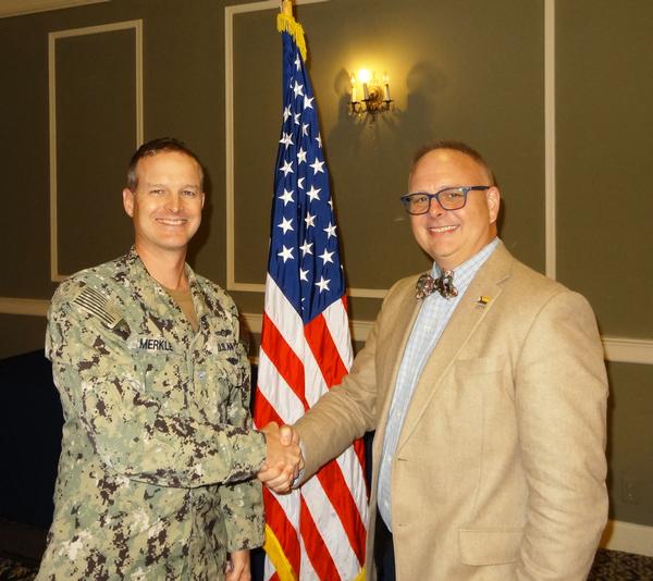 In October, John Sahlin, vice president, Cyber Solutions, General Dynamic Information Technology (GDIT), Falls Church, Virginia (r), poses for a photo with Capt. Merkle.