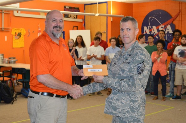 Chapter President Master Sgt. David Way, USAF (r) presents the Gravely Grant for the 2015-2016 academic year to Gulfport High School's Clint Brawley at an event in August. 