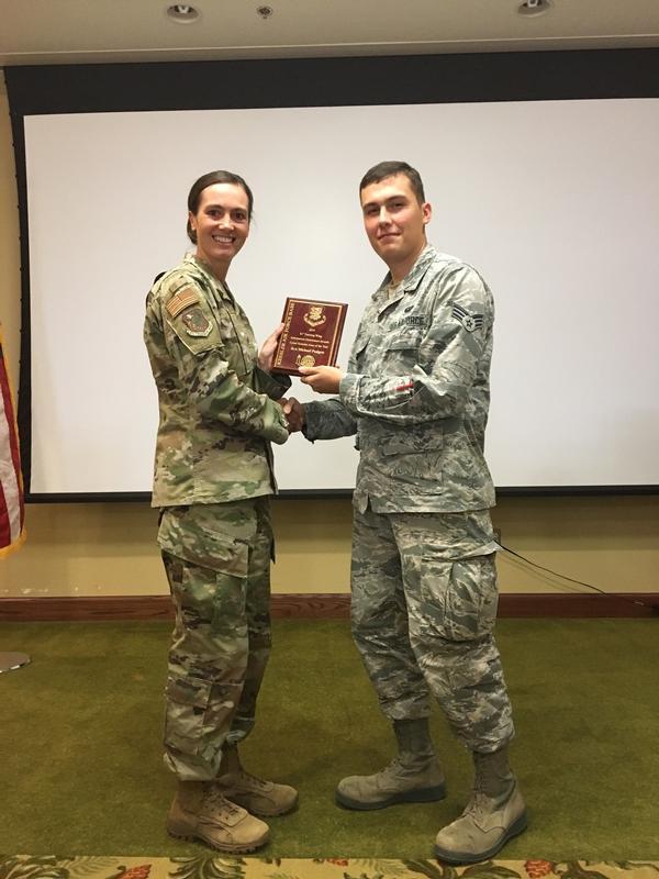 Col. Heather Blackwell, USAF, commander, 81st Training Wing, Keesler Air Force Base, Mississippi, presents Information Dominance Awards for the 81st Training Wing to Senior Airman Michael Padgett, USAF, at the October luncheon.