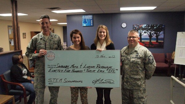 In November, Capt. Lewis (l) and Master Sgt. Scott Fridinger, USAF (r), chapter Scholarship Committee member, recognize scholarship winners Savannah Metz (2nd from l) and Lindsay Raybourne of Gulfport high School.