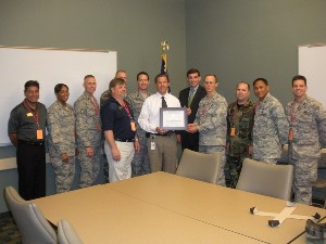 Chapters members present a certificate of appreciation to Shane Loper, chief information officer, and Ron Millet, information technology director, both from the Hancock Bank Technology Center, who led the chapter on a tour of the center in May.