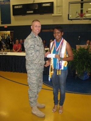Capt. Robert Curran, USAF, chapter treasurer, presents Gabrielle Davis with a scholarship at the St. Martin High School award ceremony, held in May.