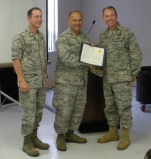 Col. Christopher Valle, USAF (l), vice commander, 81st Training Wing, and Lt. Col. Scott E. Solomon, USAF (r), commander, 333rd Training Squadron, and chapter president, present Maj. Gen. John Maluda, USAF, director, cyberspace transformation and strategy, Office of Warfighting Integration, Secretary of the Air Force, and chief information officer, the Pentagon, Washington, D.C., with a token of thanks. The general spoke at the April meeting.