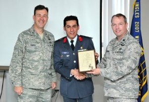 Col. din Khaled (c) receives a token of appreciation from Brig. Gen. Gregory J. Touhill, USAF (l), 81st Training Wing, and Lt. Col. Scott E. Solomon, USAF, 333rd Training Wing, and chapter president, for serving as the featured speaker at the March meeting.