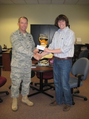 In May, Lt. Col. Scott E. Solomon, USAF (l), commander, 333rd Training Squadron, and chapter president, presents Tanner Reid of Vancleave High School with a scholarship.