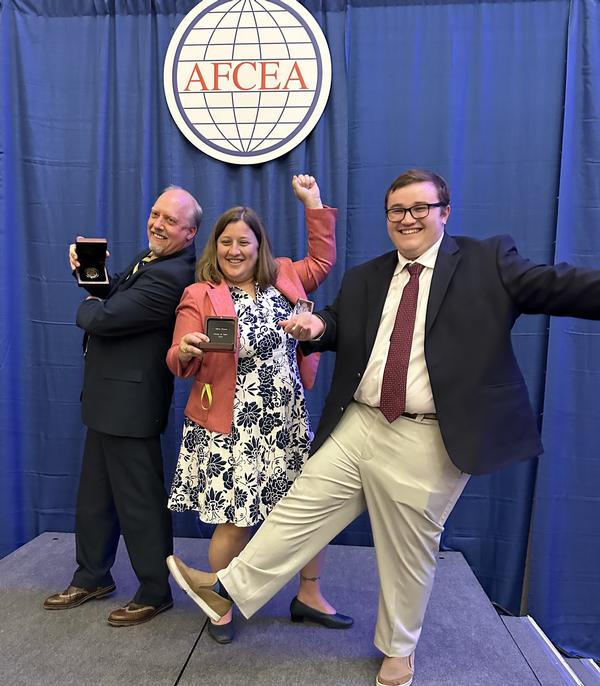 In April, (l-r) Larry Minnick, Hillary Boyce and Matthew Umphlet show off their awards at TechNet Cyber in Baltimore.
