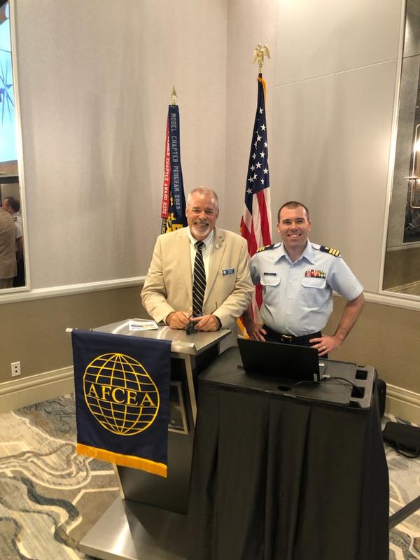 In August, Tim Harschutz, chapter president (l), pauses for a photo with guest speaker, Jonathan White, USCG, commander. 
