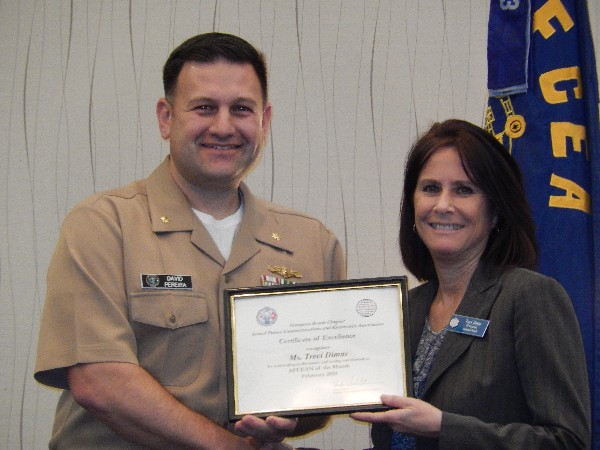 Lt. Cmdr. Dave Pereira, USN (l), chapter Young AFCEAN chair, awards Treci Dimas with the February AFCEAN of the Month Award.